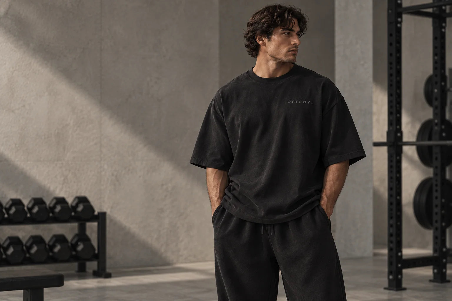 Boxy black essentials in a gray stone gym